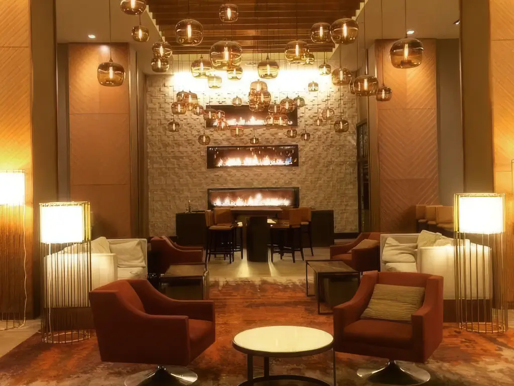 Multiple Acucraft custom gas single-sided fireplaces in a tall hospitality lounge