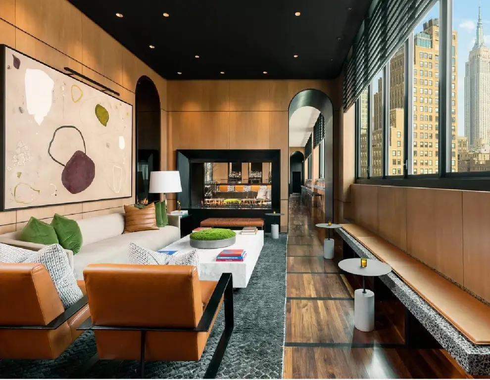 Acucraft tall linear see-through gas fireplace beside seating and shelving