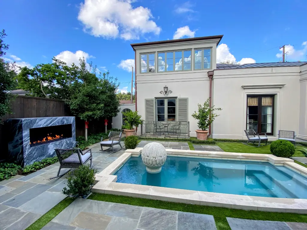 Acucraft custom open outdoor gas fireplace beside a luxury pool