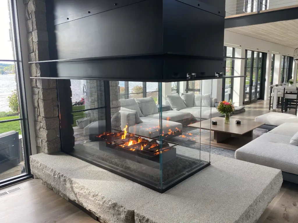 Three-sided Acucraft custom peninsula gas fireplace connecting living areas