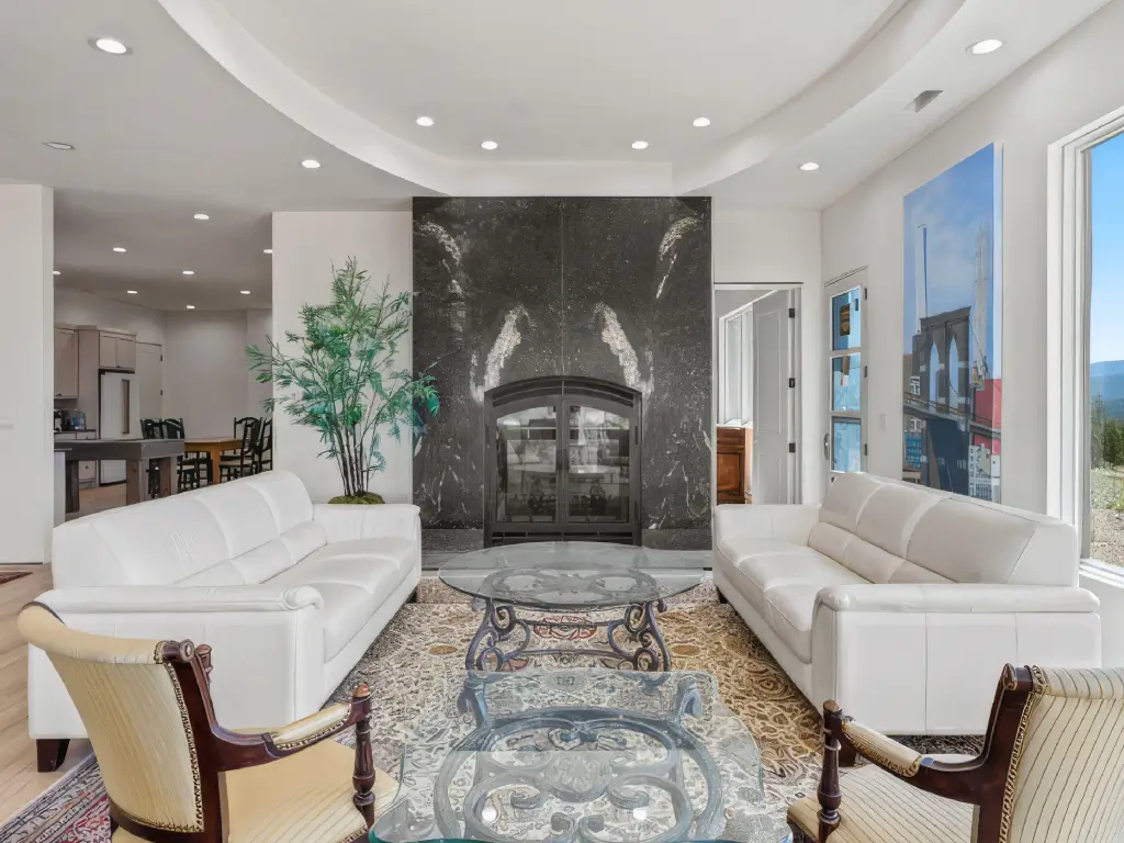 Acucraft Hearthroom 48 see-through wood fireplace in a bright luxury living room