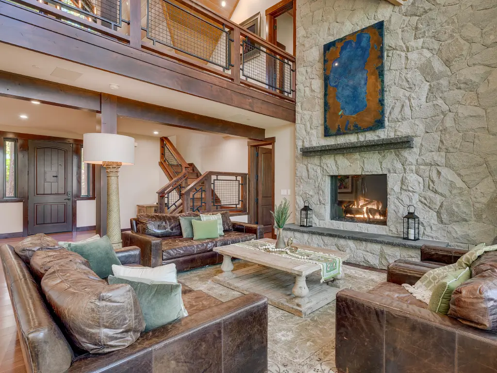 Acucraft Timeless see-through gas fireplace in a stone wall between rooms