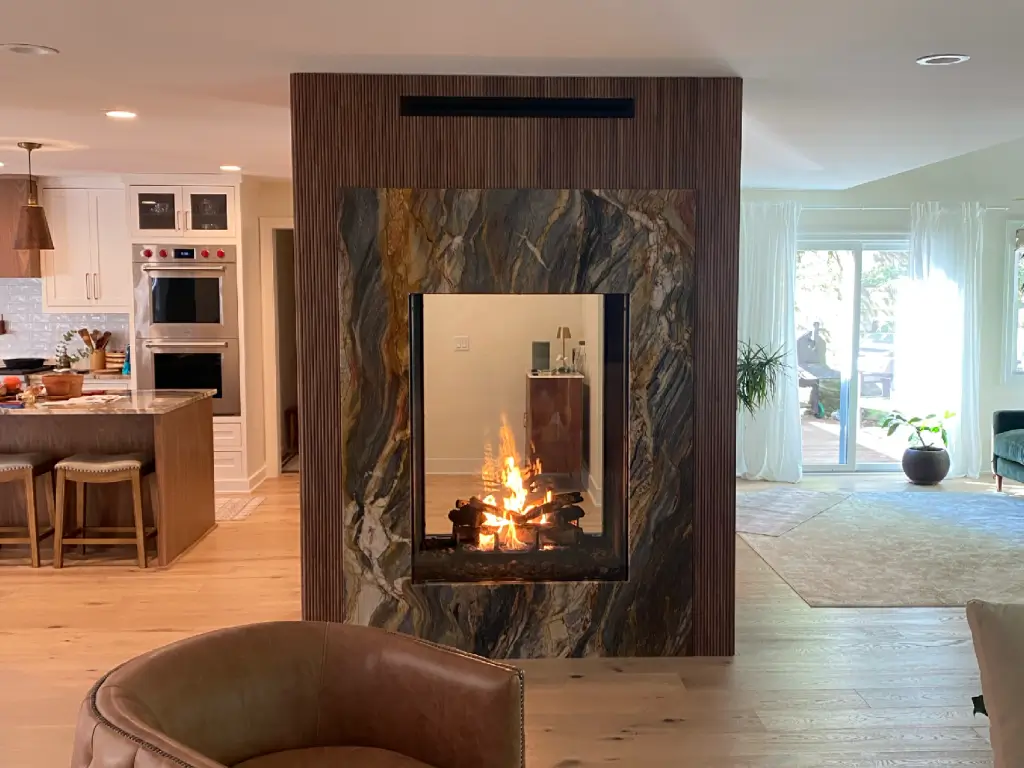 Acucraft Timeless see-through gas fireplace dividing a kitchen and living room