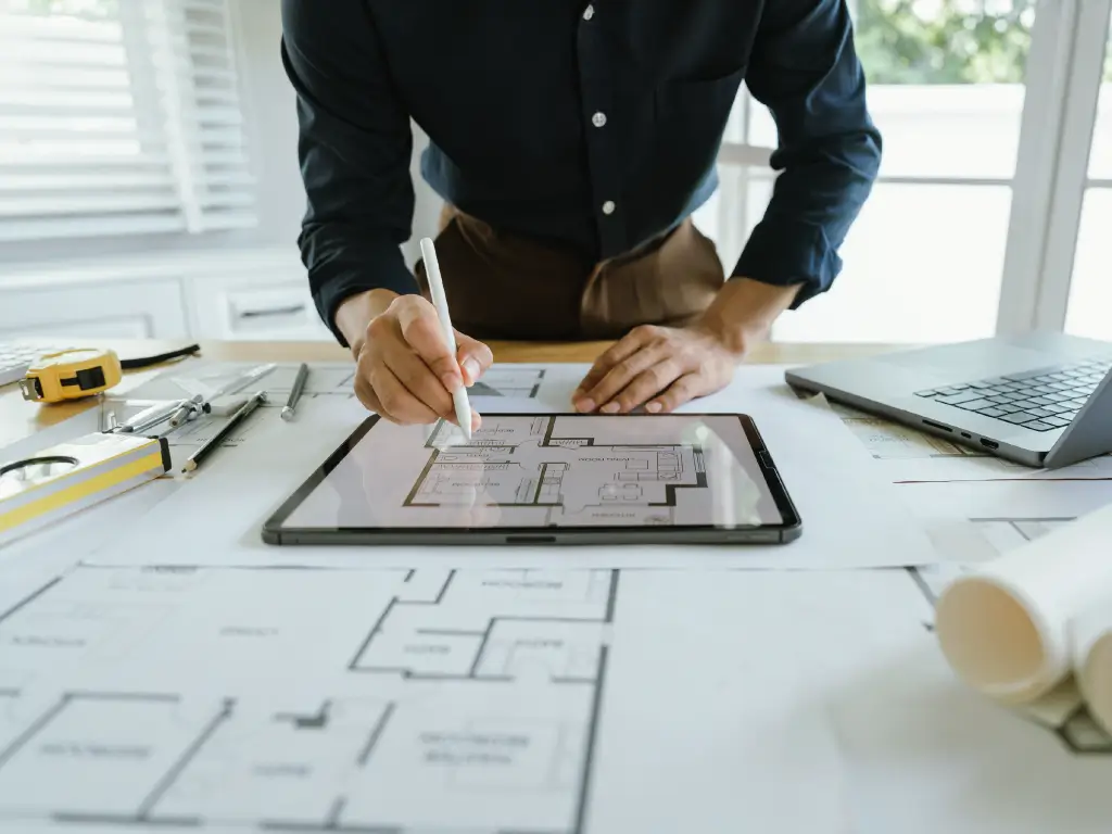 Designer planning smart fireplace technology on a digital floor plan