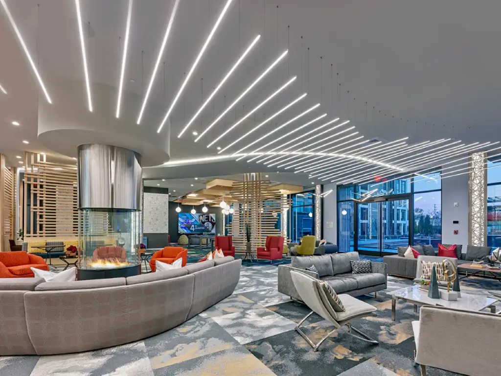 Acucraft circular gas fireplace anchoring a bright contemporary lounge with curved seating.