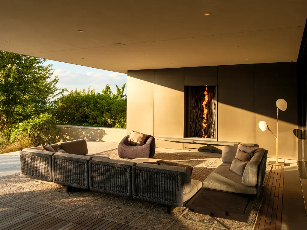 Tall Acucraft single-sided outdoor gas fireplace on a covered luxury terrace.
