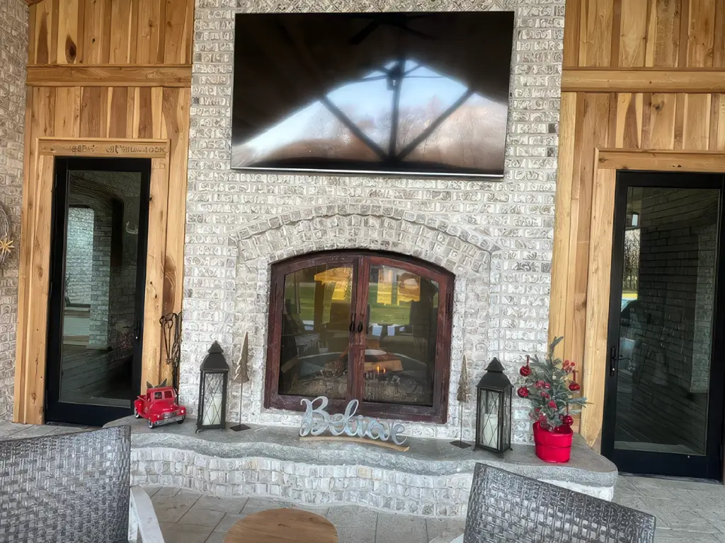Acucraft indoor-outdoor wood fireplace in a bright covered gathering area