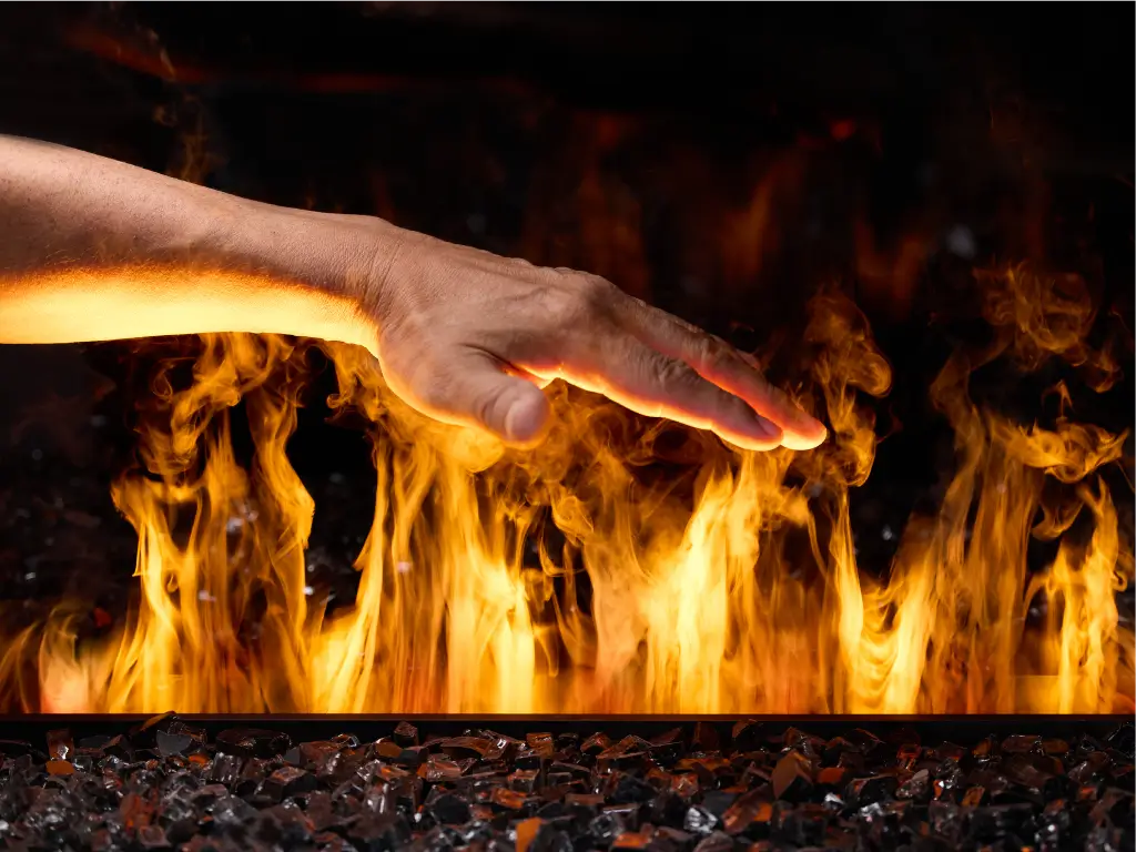 Hand held above the cool flame effect of an Acucraft water vapor fireplace.